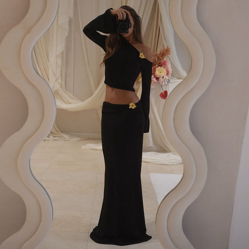 Model wearing the Sabrina ensemble featuring an asymmetrical black top and a fitted skirt with floral details.